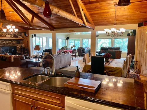 a kitchen with a sink and a living room at Lake Escape To An Elegant 4 Br Home in Huddleston