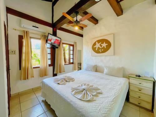 Cama ou camas em um quarto em Pousada Vila do Sol Juquehy