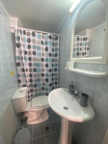 a bathroom with a sink and a toilet and a mirror at spla apartments 3 , Διαμέρισμα στην πόλη των Χανίων in Chania Town