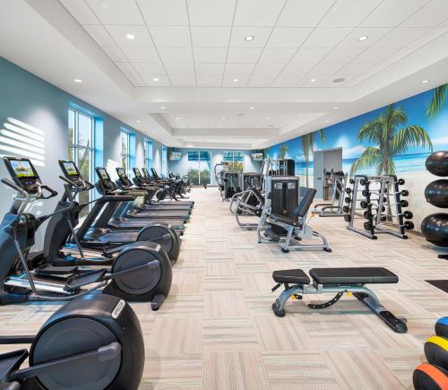 a gym with a row of treadmills and exercise bikes at Margaritaville Beach Resort Ft Myers Beach in Fort Myers Beach