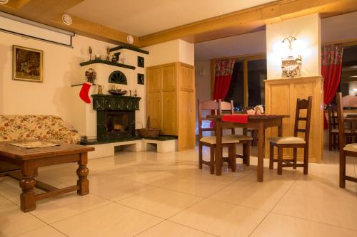 a living room with a couch and a fireplace at Willa Alpejska in Wisła