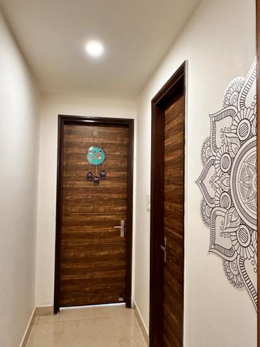 a hallway with a wooden door and a wall at Yoga Retreat at The Ganges in Rishikesh in Rishīkesh