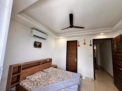 a bedroom with a bed and a ceiling fan at Yoga Retreat at The Ganges in Rishikesh in Rishīkesh