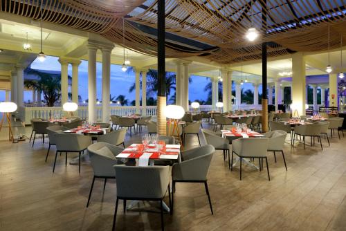 a restaurant with tables and chairs and lights at The Signature Level at Grand Palladium Lady Hamilton Resort & Spa- All Inclusive in Lucea