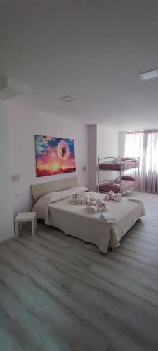 a bedroom with two beds and a painting on the wall at B&B PalmaViola in Caserta