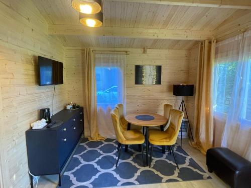 a dining room with a table and chairs in a room at Saulkrasti Beach Cottage in Saulkrasti