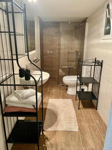 a bathroom with a tub and a toilet and a sink at Evangeo Seaview Apartment Epanomi in Epanomi