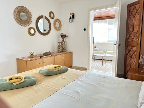 a bedroom with a bed with two towels on it at Evangeo Seaview Apartment Epanomi in Epanomi