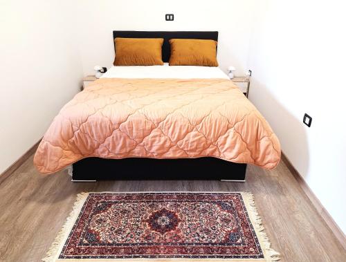a bedroom with a bed and a rug at Apartments ROKO in Izola