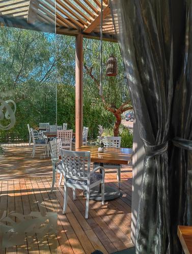 a wooden deck with a wooden table and chairs at Alesia - Boutique Hotel & Spa in Aguascalientes