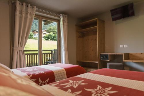 Ένα ή περισσότερα κρεβάτια σε δωμάτιο στο Alpen Chalet - Charme Mountain Hotel -