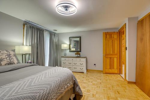 a bedroom with a bed and a dresser and a mirror at Keuka Lake Cabin with Boat Dock Access and Fire Pit! in Hammondsport