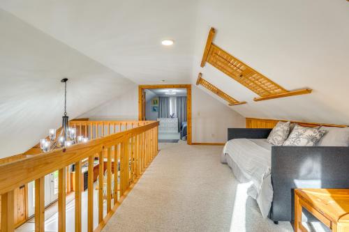 a living room with a bed and a staircase at Keuka Lake Cabin with Boat Dock Access and Fire Pit! in Hammondsport