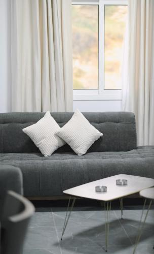 a living room with a couch with pillows and a table at Chouf View Residence in Baddah