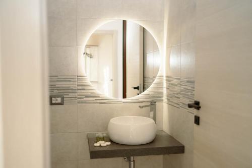 a bathroom with a sink and a mirror at Romano's Luxury Stay b&b Bari in Bari