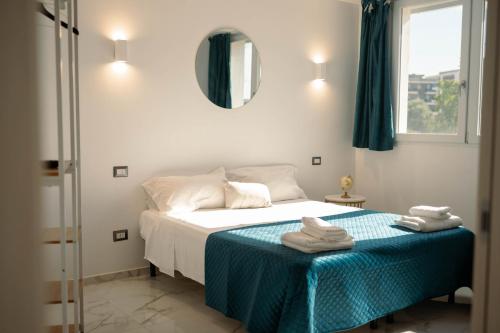 a bedroom with a bed with towels on it at Romano's Luxury Stay b&b Bari in Bari
