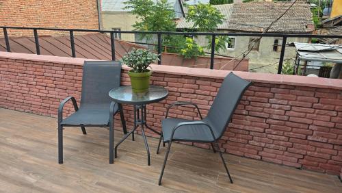 two chairs and a table on a balcony at Tbilisi Center Hotel in Tbilisi City