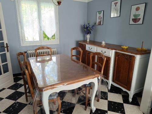 a dining room with a table and chairs at La Maison de LULU proche baie de Somme in Eu