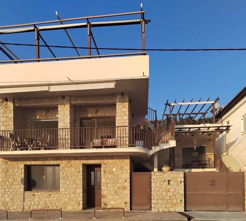 a building with a balcony on the side of it at Marvel Sea View 3 in Akrogiali