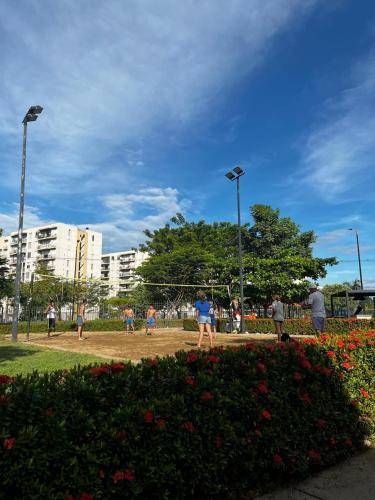 a group of people playing in a park at Confortable Apto en Hacienda Peñalisa in Ricaurte