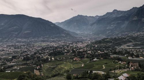 an aerial view of a town in the mountains at Picea am Ötzerhof 1 in Merano