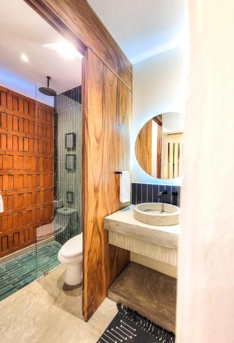 a bathroom with a toilet and a sink and a shower at Caracola Boutique Hostel in El Paredón Buena Vista