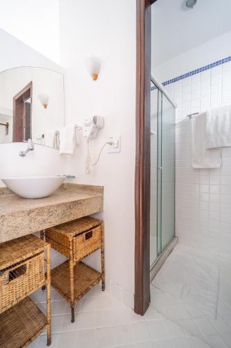 a bathroom with a sink and a shower at Pousada Porto Fino in Cabo Frio