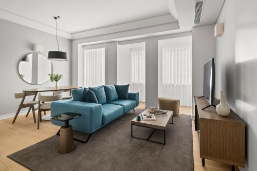 a living room with a blue couch and a table at Mirabilis Apartments - AAA23 in Lisbon