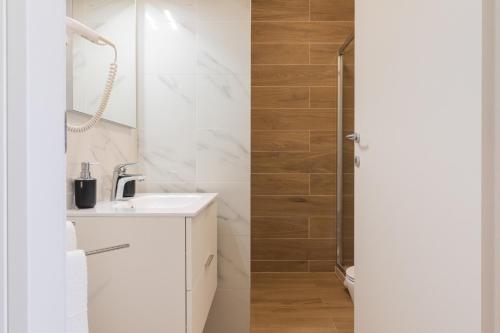 a white bathroom with a sink and a shower at Casa LiLu by Comorooms in Como