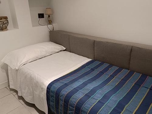a small bed in a small room with a bed sidx sidx sidx at Casa Vacanze Margarita in SantʼAlessio Siculo