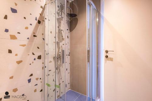 a bathroom with a shower with a climbing wall at Magisto Loft in Nea Moudania