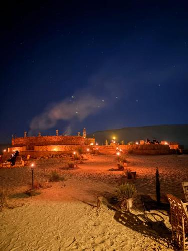 a beach at night with a building in the background at Hayaat siwa hot spring in Siwa