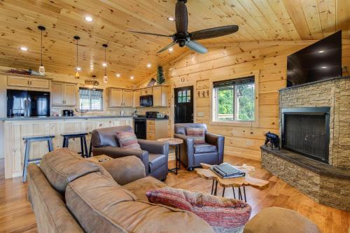 a living room with a couch and a fireplace at Gorgeous Gatlinburg Cabin Large Deck and Hot Tub! in Gatlinburg