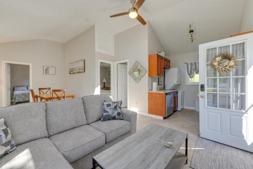 a living room with a couch and a table at Close to Beach and P-Town! Cottage with Bay Views in Truro