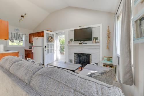 a living room with a couch and a fireplace at Close to Beach and P-Town! Cottage with Bay Views in Truro