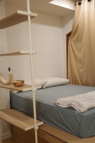 a bedroom with a bed with a wooden shelf at Daisy B in Hat Yai