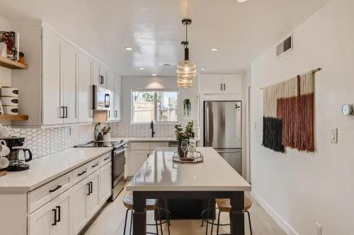 a kitchen with white cabinets and a table in it at Luxury Condo in Old Town Scottsdale wPool in Scottsdale