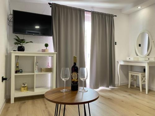 a living room with a table with two wine glasses at Studio apartment Adrijana in Zagreb