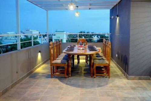 a table and chairs on a balcony with a view at Elite Enclave - Tellus - 2BHK - Luxury Serviced Apartments in Mysore