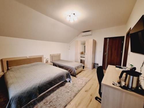 a bedroom with a bed and a desk with a desk at TREND in Arad