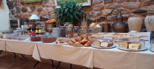 a table with bread and other food on it at Posada Ormas in Ormas
