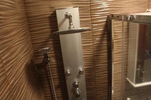 a shower stall with a shower head on a wall at Apartment Ivan in Račišće