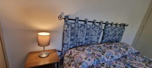 a bedroom with a bed and a lamp on a table at Villa Red Melons Portoscuso in Portoscuso