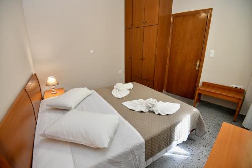 a small room with a bed with towels on it at Elli's Private House in Ialyssos