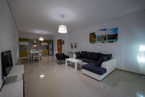 a living room with a couch and a table at Franklin Rooms in Sarandë