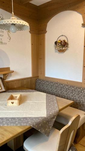 a room with a table and a table and chairs at Residence Lastè in Moena