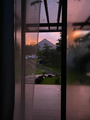 a view of a mountain through a glass door at Natura Bungalows in Fortuna
