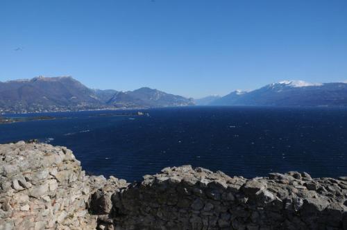 a large body of water with mountains in the background at Residence Boschetti in Manerba del Garda