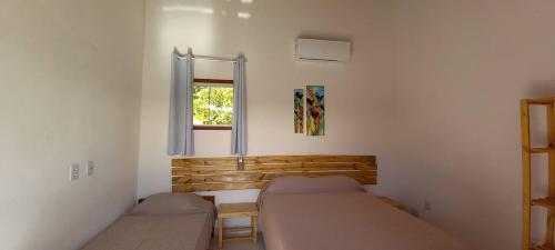 a bedroom with two beds and a window at Casa Sol in Prado