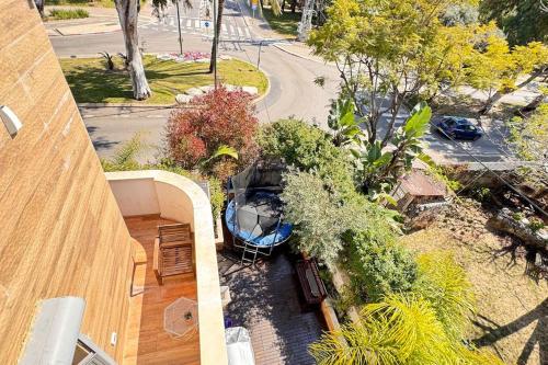 an overhead view of a balcony of a building with plants at TEL AVIV -yafo in Tel Aviv